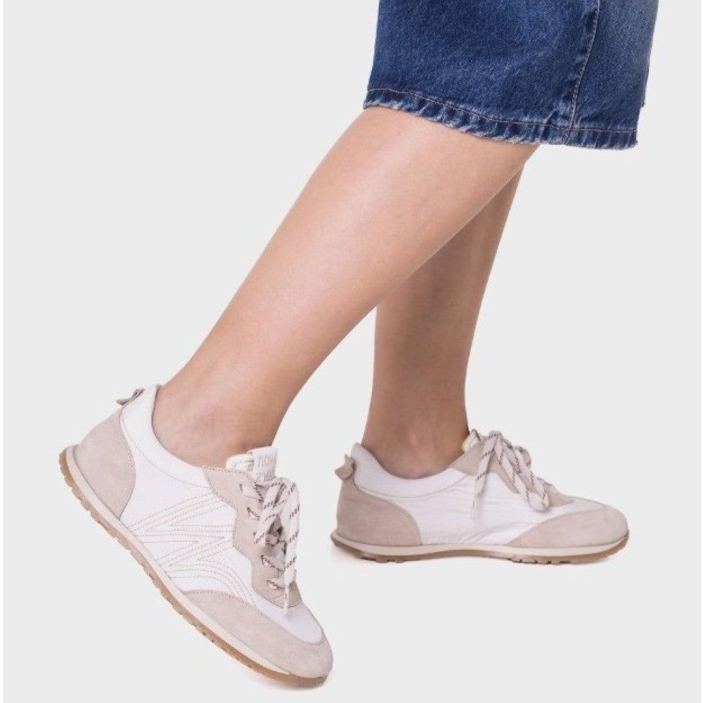 Wonders White sneakers with beige accents worn by a person on a light grey background