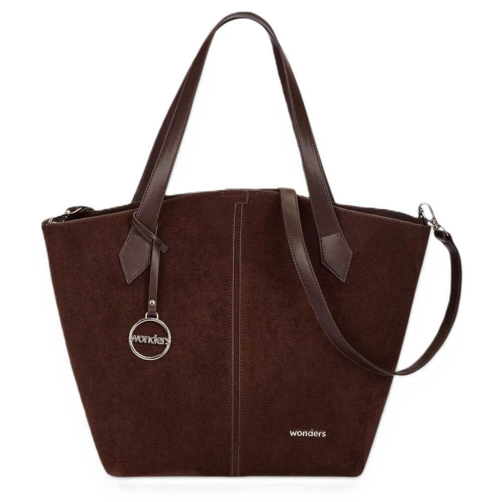 A Wonders dark brown suede tote bag with dark brown leather handles and a silver-tone hanging logo charm, shown on a plain white background.