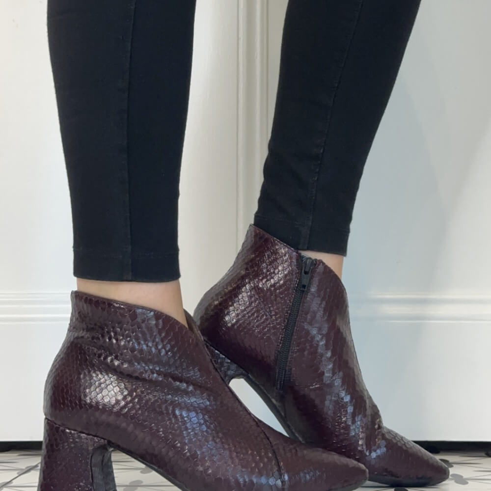 Wonders women's snakeskin-textured ankle boots in a deep burgundy colour, shown on a model wearing black skinny jeans.