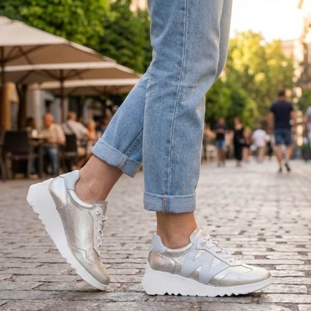 Wonders E-6770 Silver sneakers worn with rolled-up jeans on a blurred outdoor background