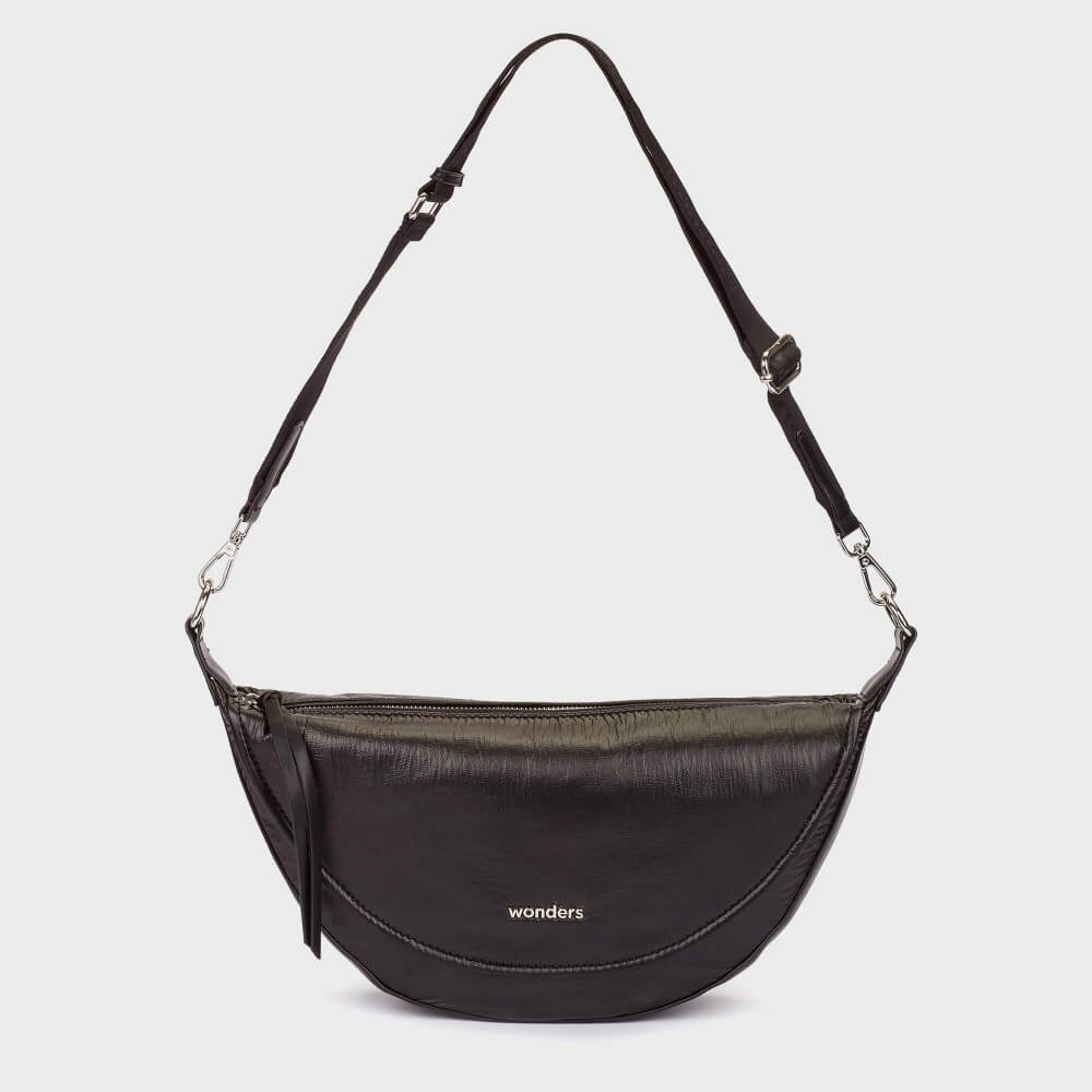 A Wonders black fabric crescent-shaped shoulder bag with a long adjustable strap and silver hardware, featuring the 'wonders' brand name in white on the front, set against a light grey background.