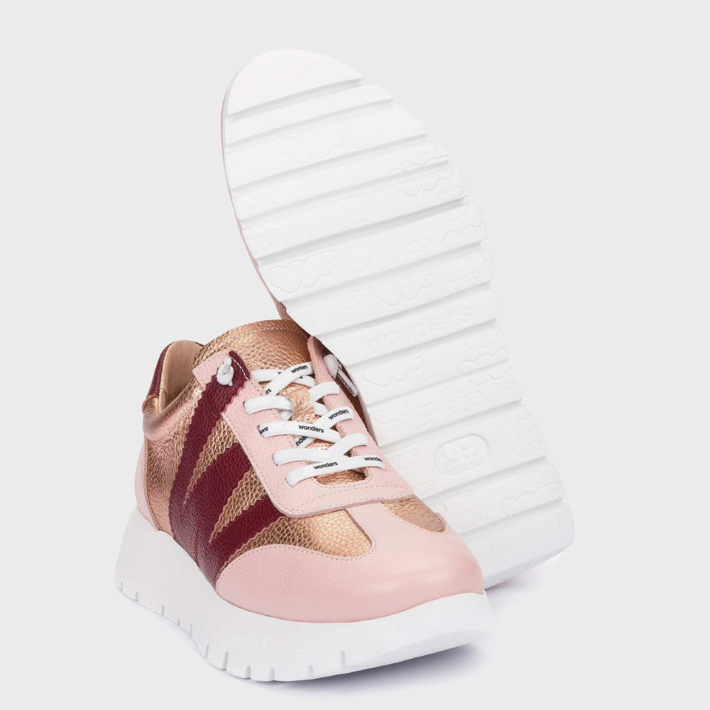 Wonders Pink and gold sneakers with white laces on a light grey background