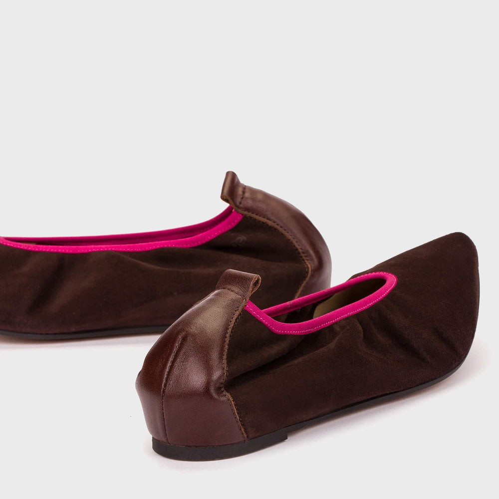 Brown shoes with pink trim on a white background