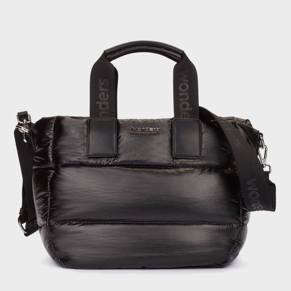 A Wonders black puffer-style tote bag with dual top handles and a detachable shoulder strap, shown on a light grey background. The handles and strap feature the brand name 'Wonders' printed vertically, and a small metallic 'Wonders' logo is centred on the front.