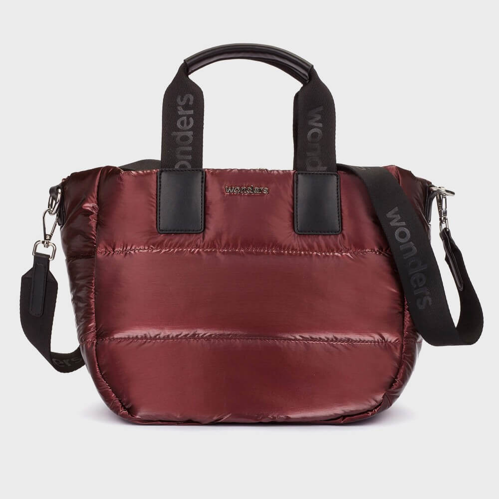 A Wonders metallic burgundy puffer handbag with black leather-like trim, dual top handles, and a detachable shoulder strap. The handles feature the brand name 'Wonders' printed vertically in black, and a small gold-tone 'WONDERS' logo is centered on the front.