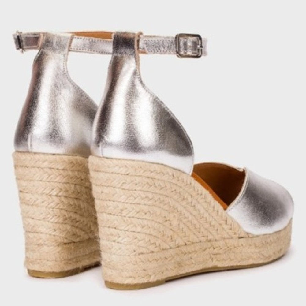 Wonders Silver wedge espadrilles with a textured sole on a light gray background