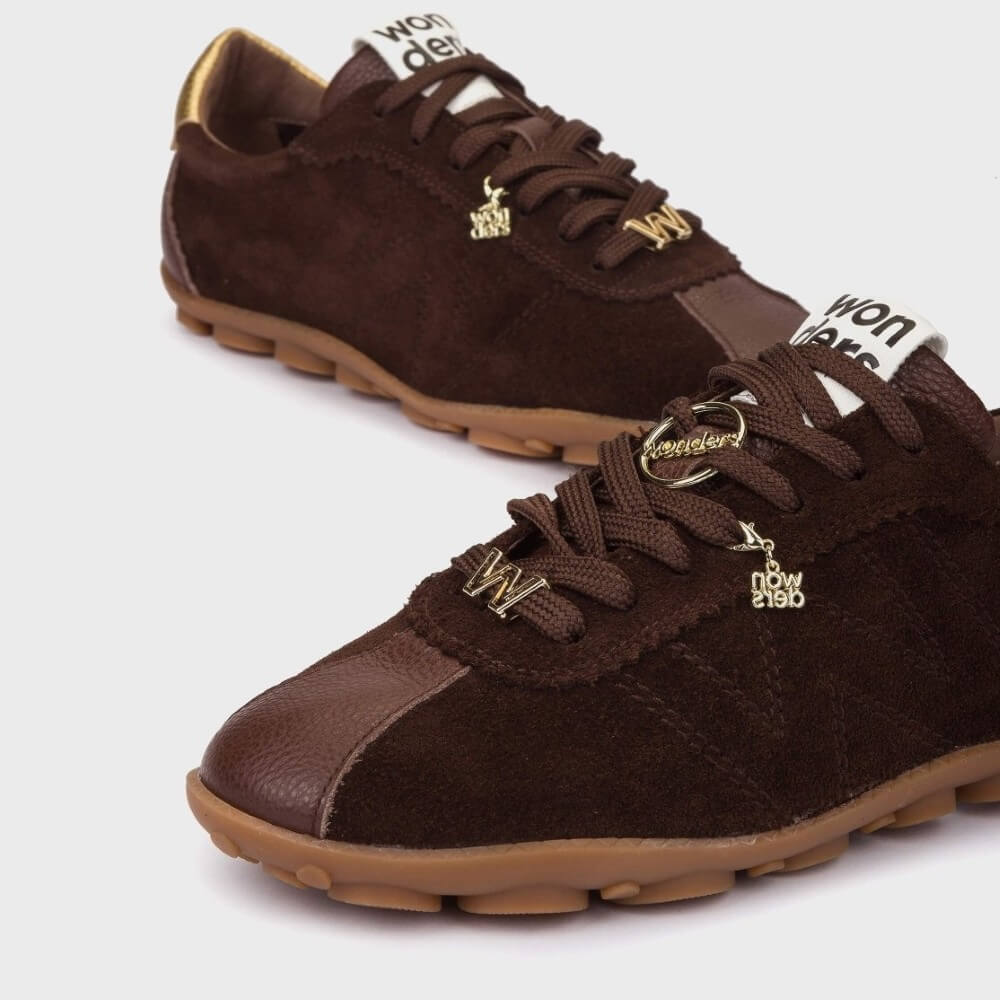 Brown sneakers with gold accents on a white background