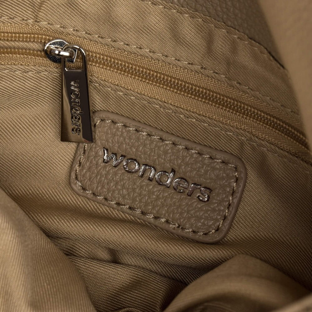 Close-up of a beige bag with 'wonders' branding and a zipper.