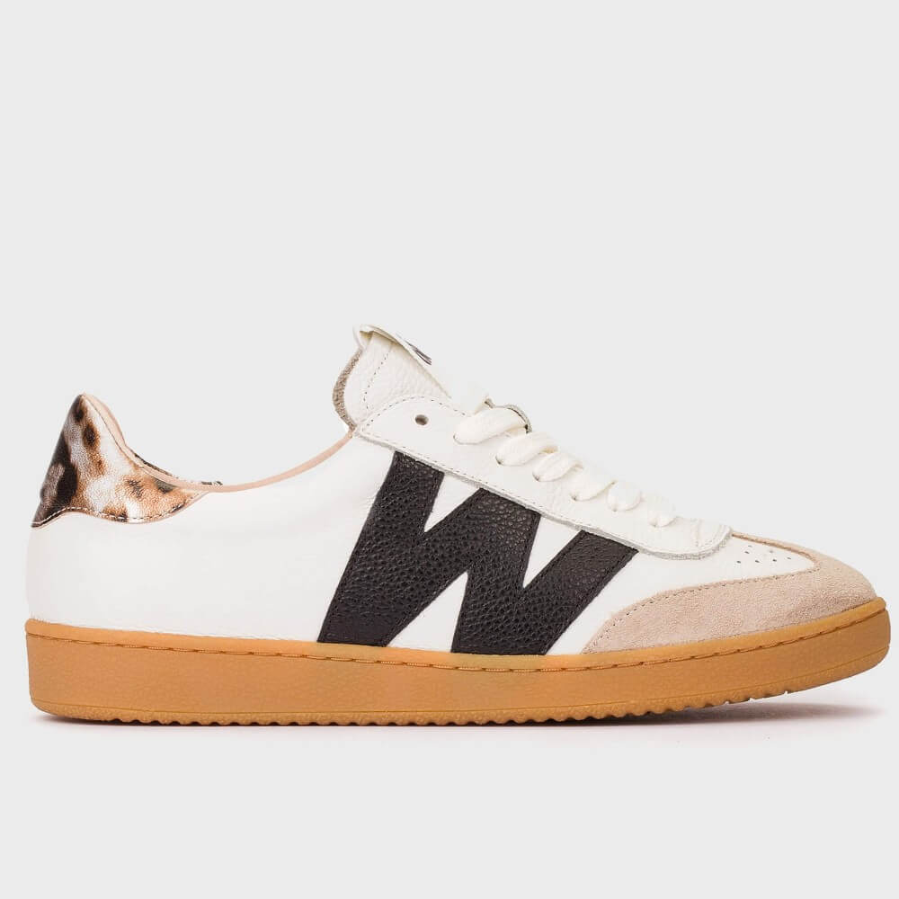 White sneaker with black pattern and brown sole on a white background