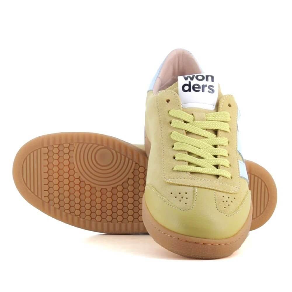 Pair of light green sneakers with brown soles on a white background