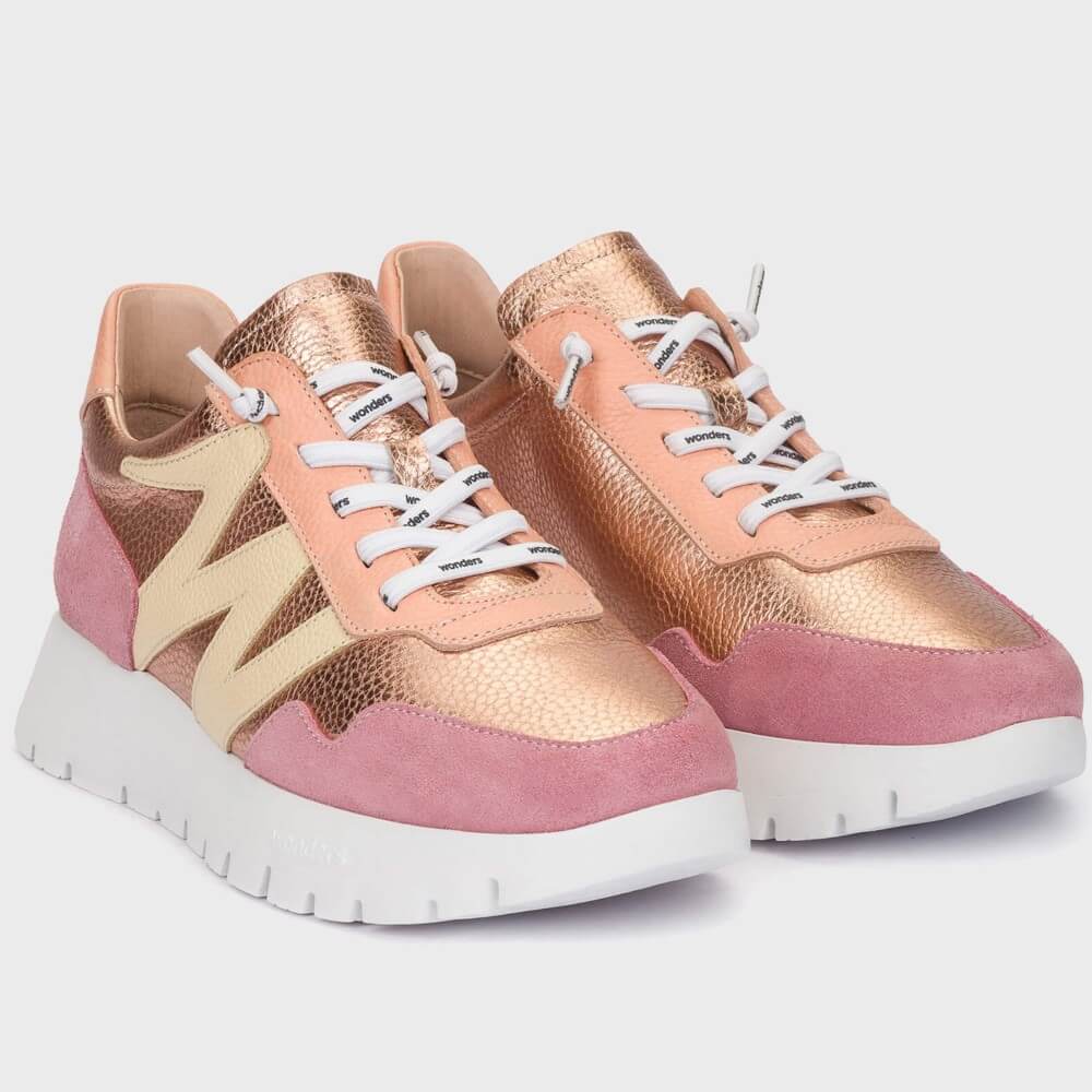 Pair of pink and gold sneakers on a light gray background