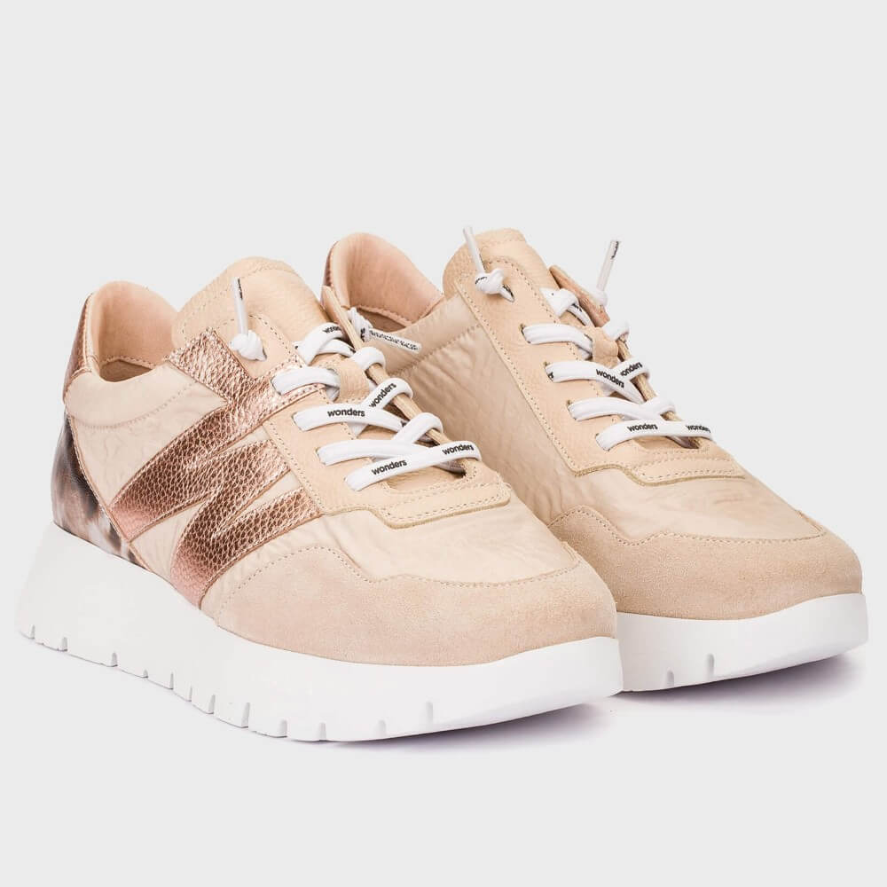 Beige sneakers with white soles on a light gray background