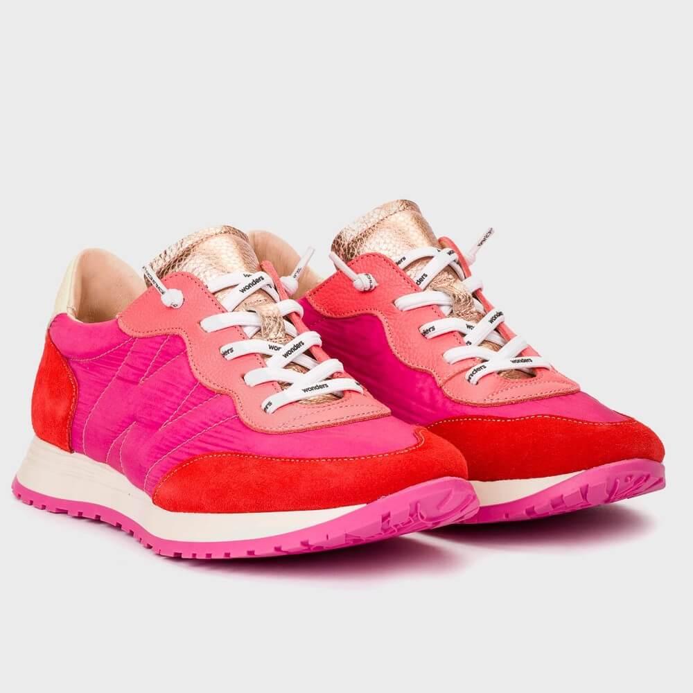 Pair of pink and red sneakers with white laces on a light gray background