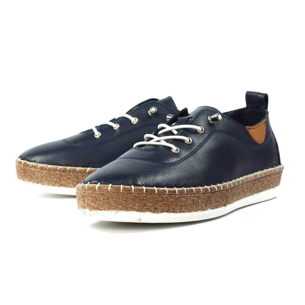 Pair of navy blue leather shoes with cork soles on a white background