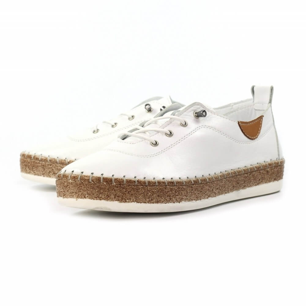 White sneakers with brown soles on a white background