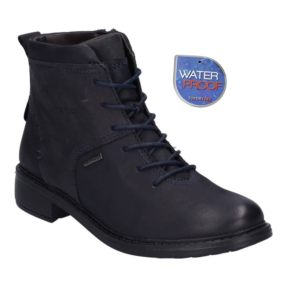 Navy lace-up boot with a waterproof label on a white background