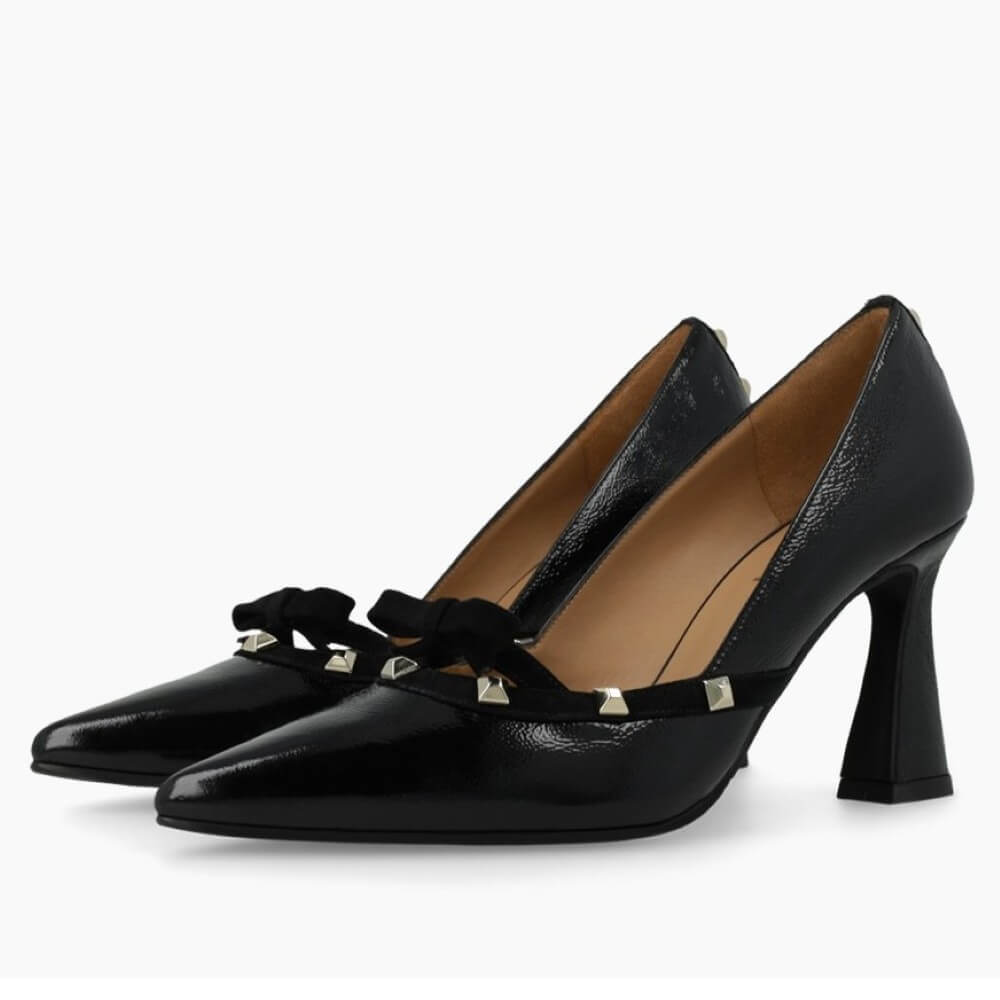 Black high-heeled shoe with decorative bow and studs on a white background Lodi RERIS pumps in black patent leather