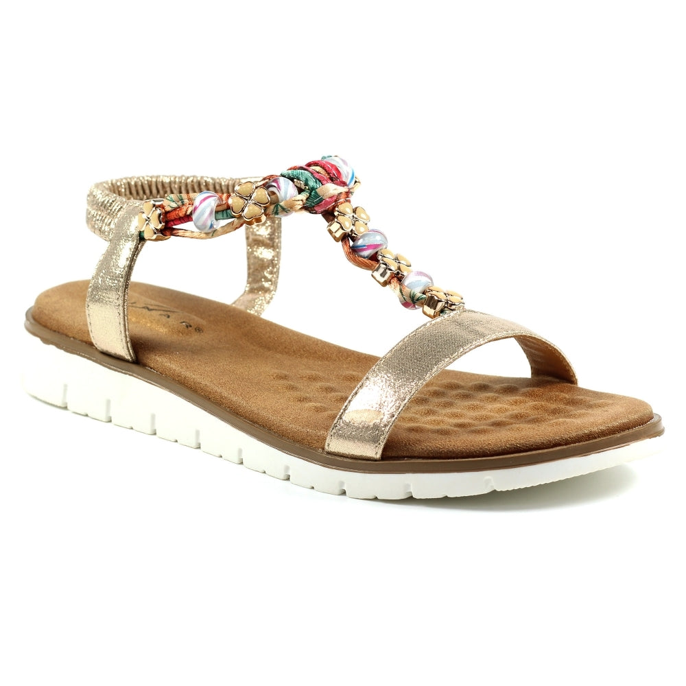 Lunar Gold sandal with a decorative strap on a white background