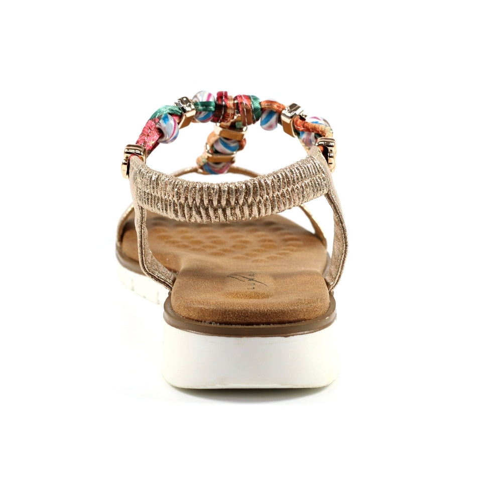 Lunar Gold sandal with a decorative strap on a white background
