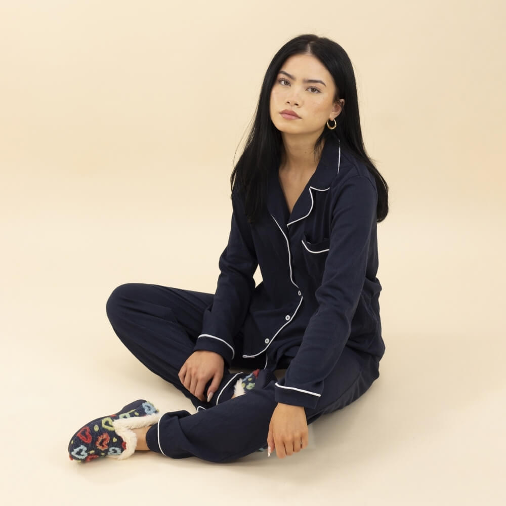 person wearing a pair of Blue Slippers with coloured hearts