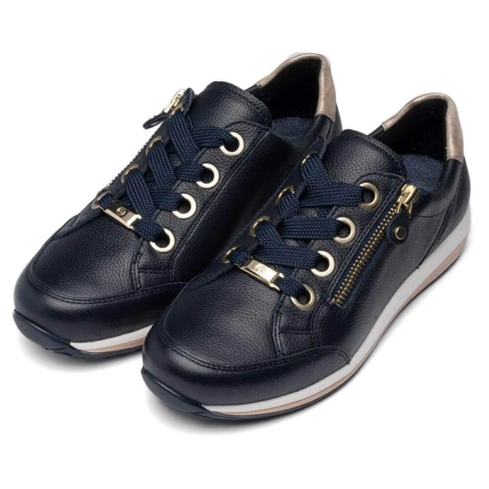 video of Navy ara sneakers with white soles worn with light blue jeans on a light grey background