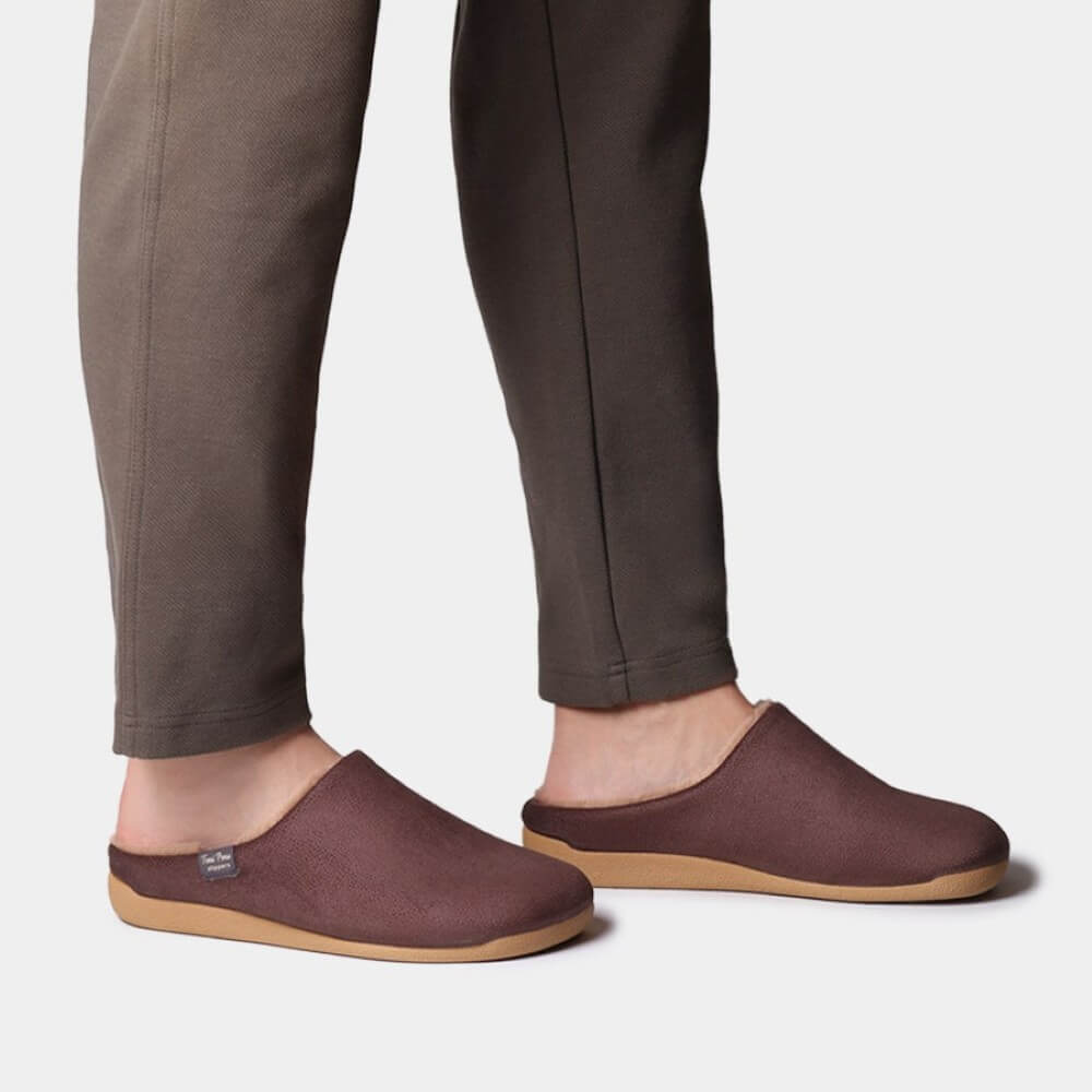 Person wearing brown slippers