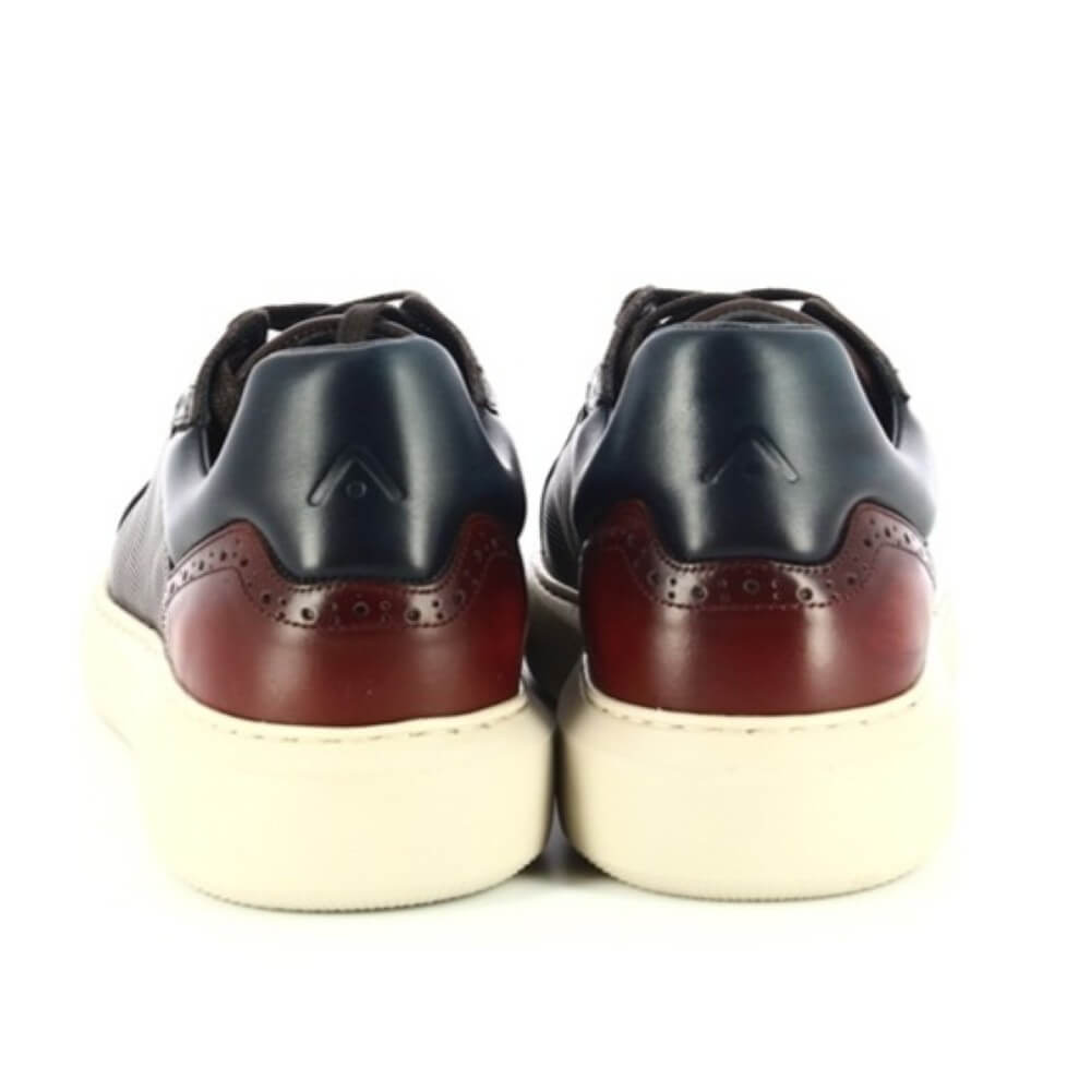 Pair of black and brown leather shoes with white soles on a white background