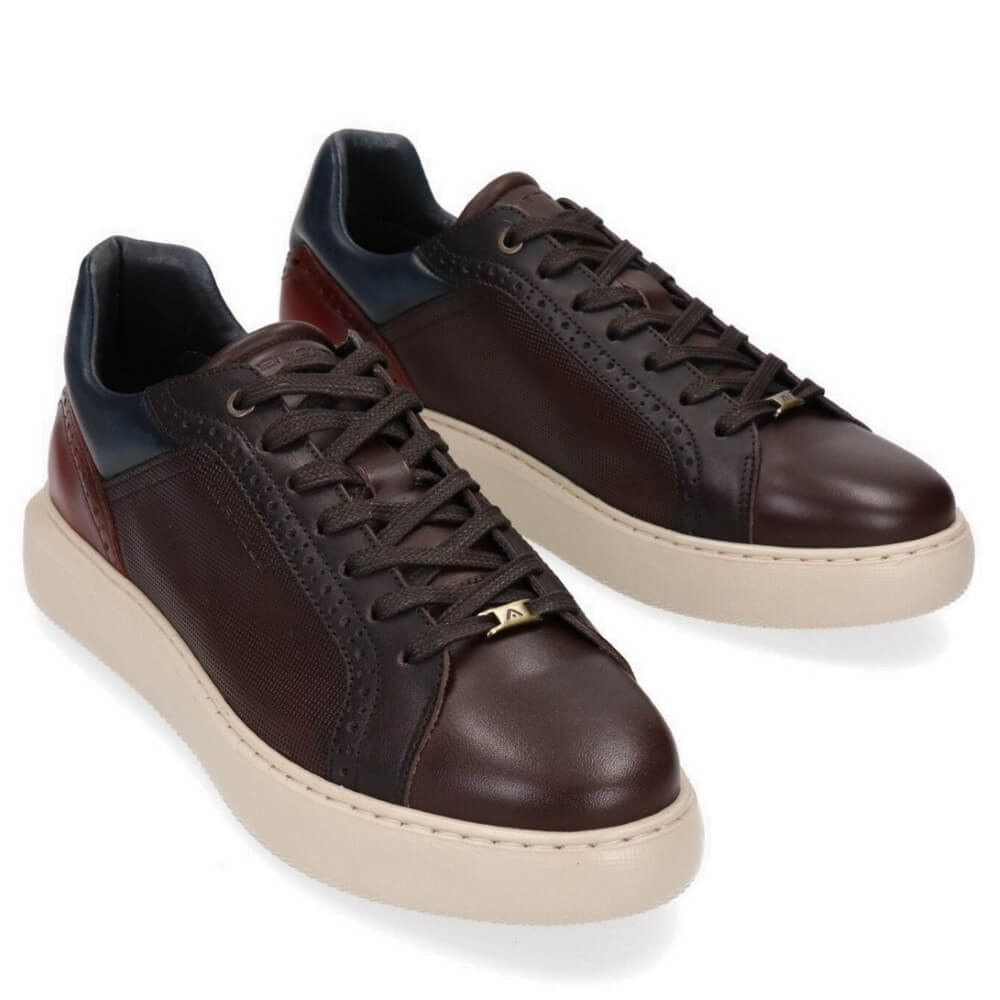 Pair of brown leather sneakers with beige soles on a white background
