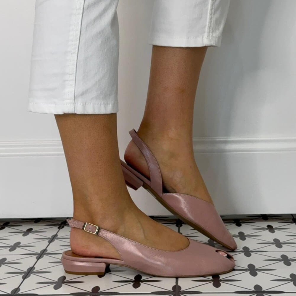  Angel Alarcon Blush Pink slingback peep toe shoes worn with white pants on a patterned floor.