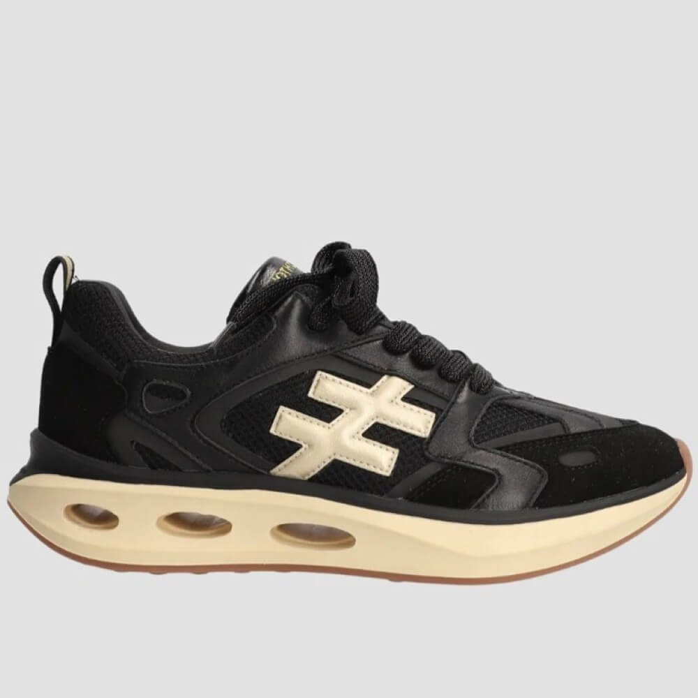 Black sneaker with a gold logo on a light gray background
