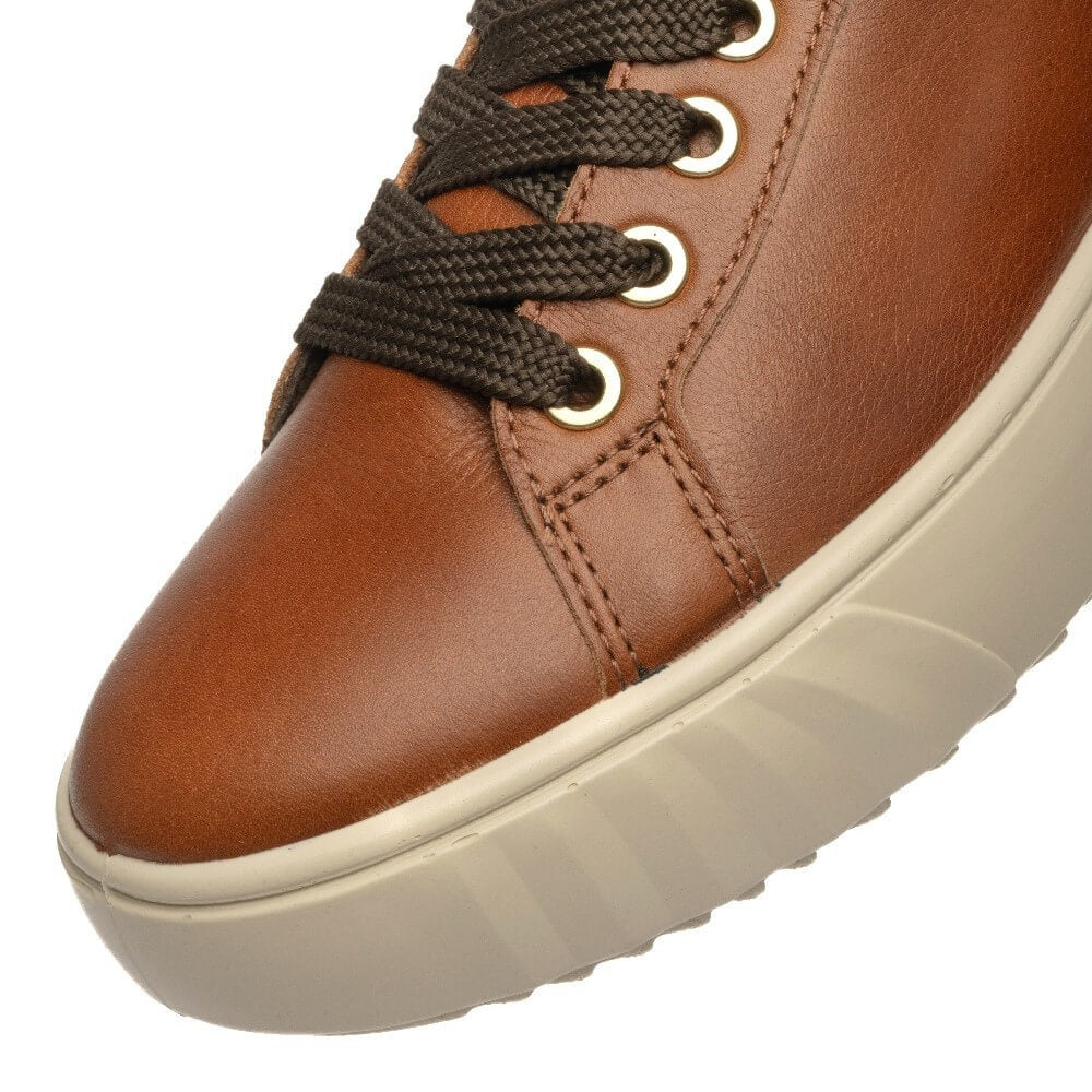 Close-up of an ara brown leather sneaker with dark brown braided laces, silver eyelets, and a thick cream-colored sole.