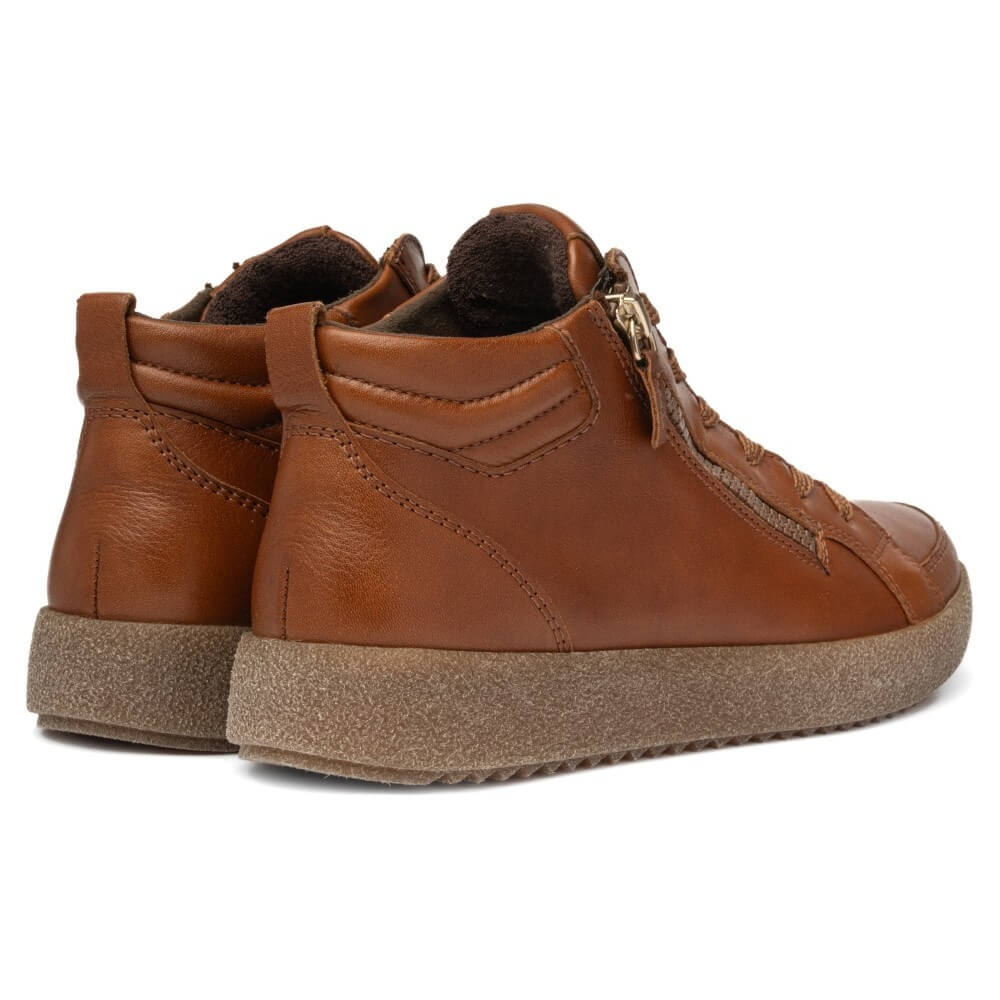 A pair of brown leather high-top sneakers with thick brown textured soles, shown from a three-quarters angle on a white background.