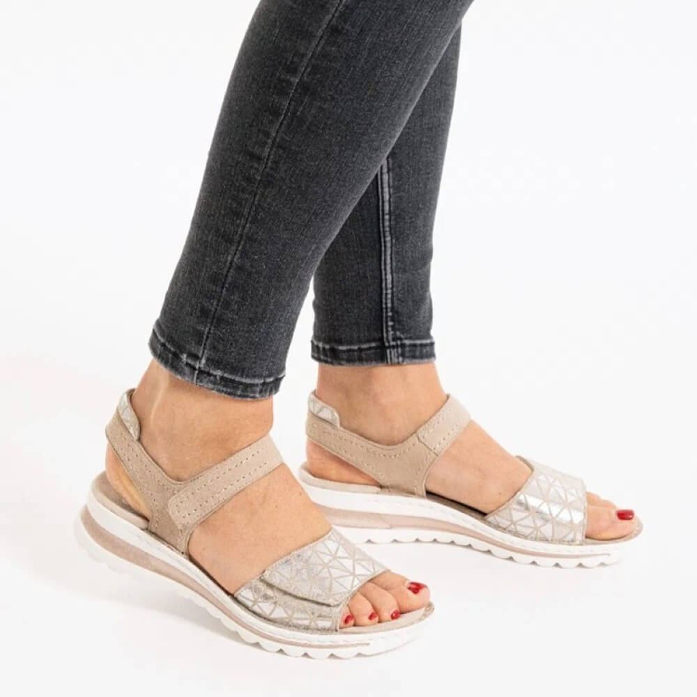 ara Beige sandals worn with dark jeans on a white background