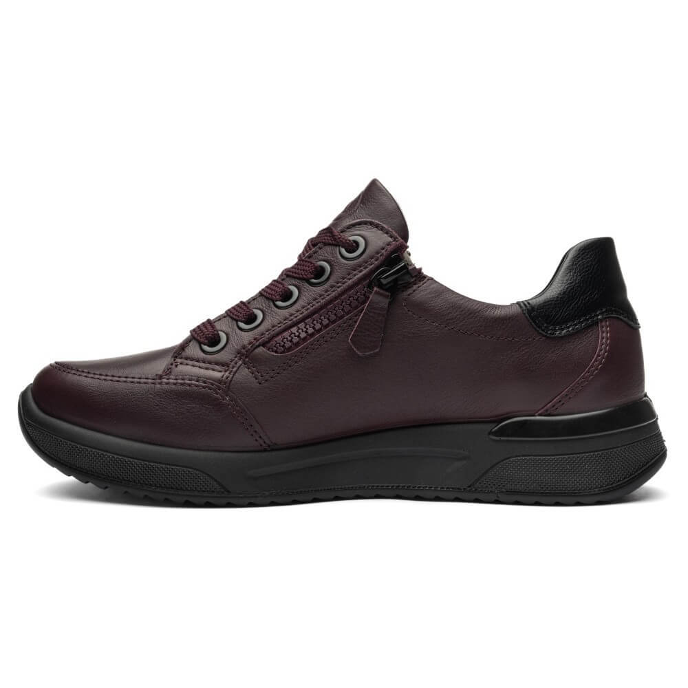 A dark burgundy leather low-top sneaker with a black sole, black heel tab, and side zipper, shown in a side profile on a white background.