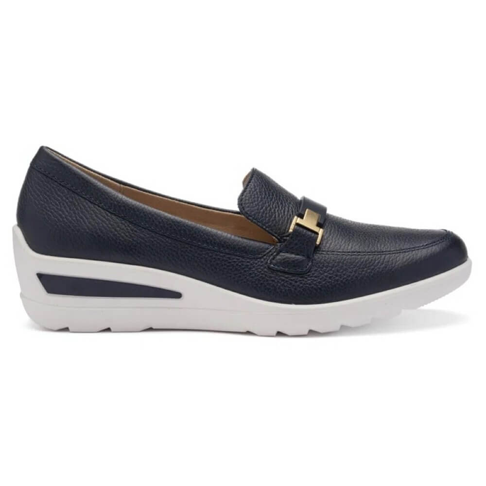 Navy loafer with white sole on a white background