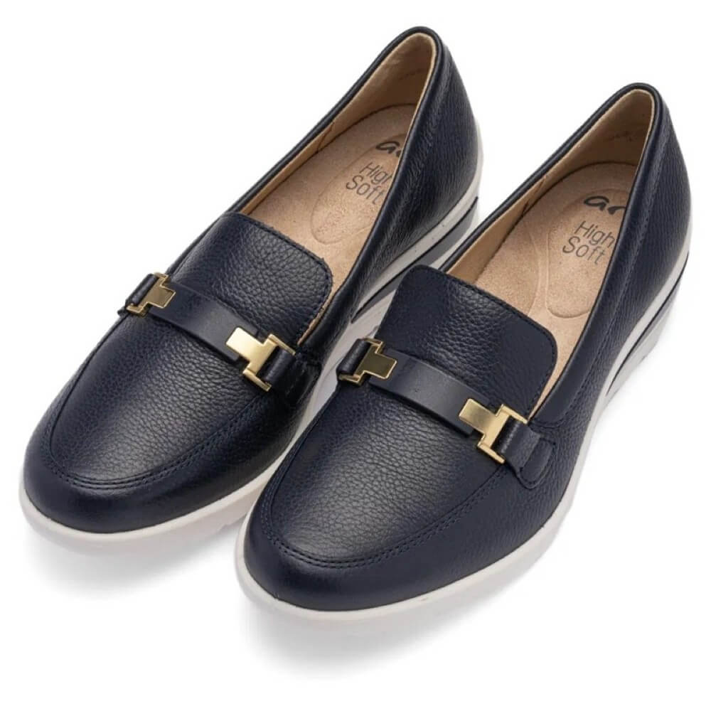 Pair of navy loafers with gold buckles on a white background