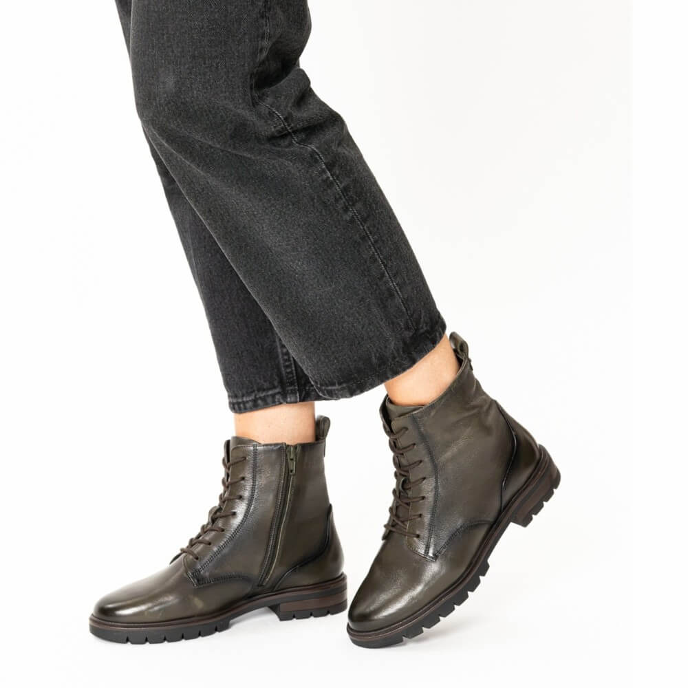 Person wearing dark green leather boots with black jeans on a white background Green  leather boot on a white background Ara Cambridge Laced Leather Ankle Boots 12-11260 Forrest Green