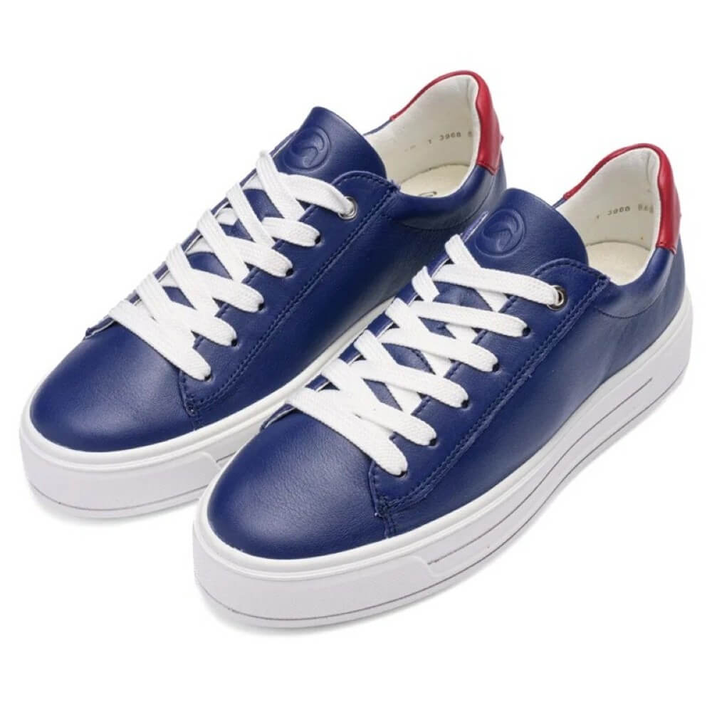 Blue sneakers with white laces on a white background