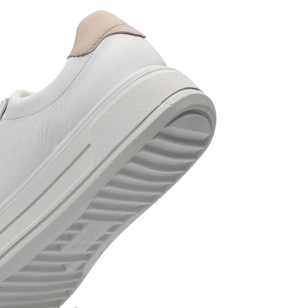 Close-up of a light gray sneaker with a white sole on a white background
