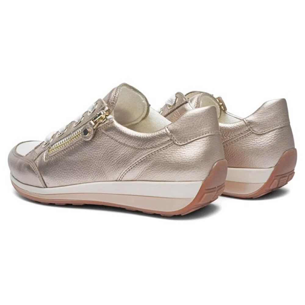 Pair of metallic gold sneakers on a white background