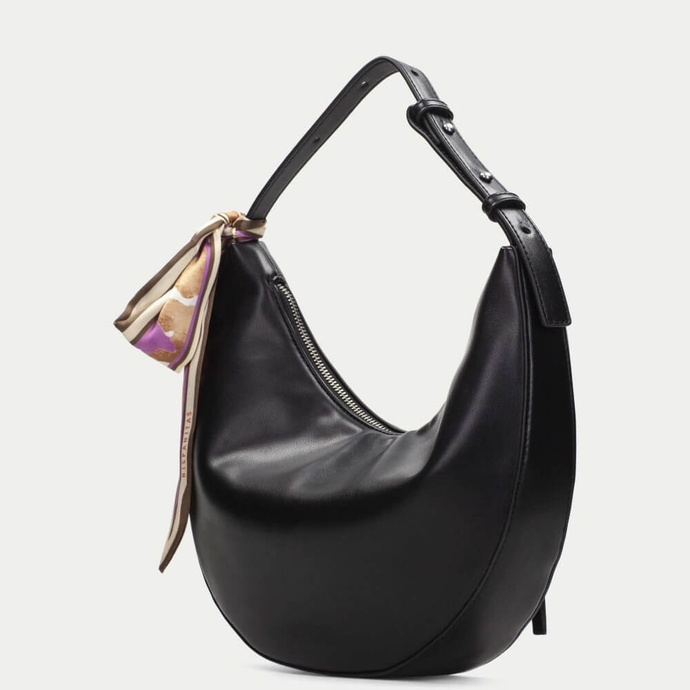 Black handbag with a decorative ribbon on a light gray background