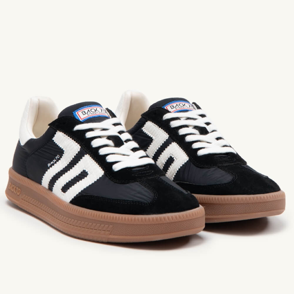 Back 70 Gents Black and white sneakers with brown soles on a white background