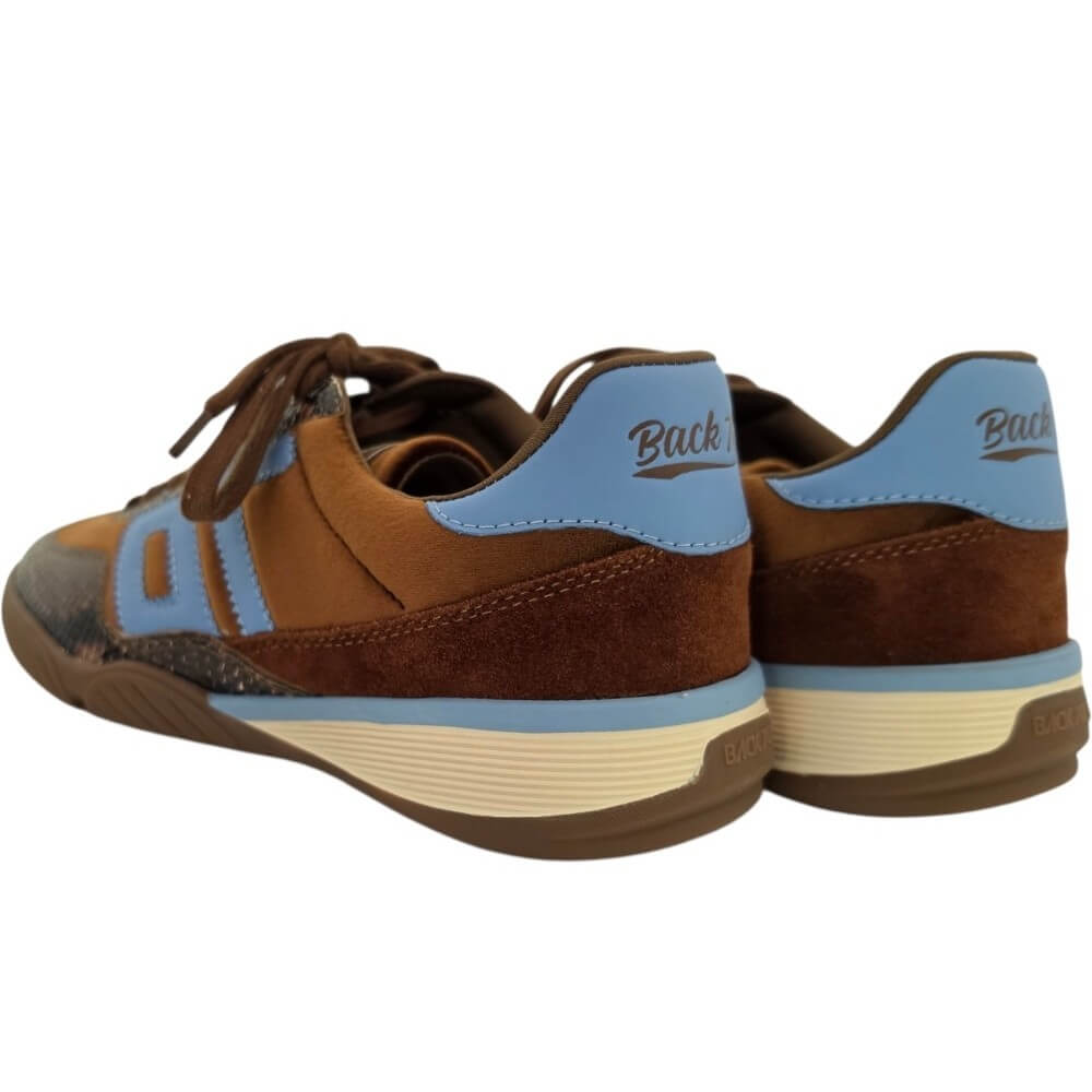 A pair of low-top sneakers shown from the back three-quarter angle, featuring brown suede and synthetic panels, light blue overlays, brown laces, and a cream-colored midsole.