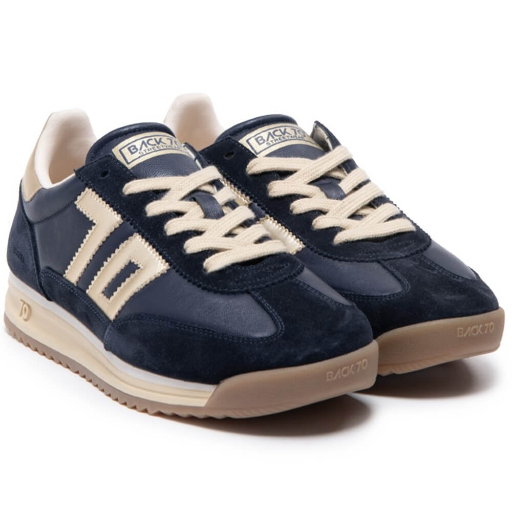 Navy blue sneaker with gold accents on a white background Back 70 Jogger N03 Navy Leather features a soft padded leather