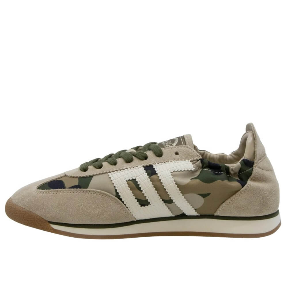Beige sneaker with camouflage pattern and white stripes on a white background
