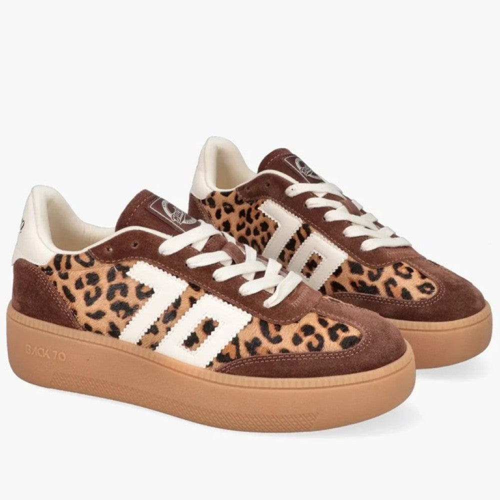 A pair of low-top platform sneakers featuring a brown and beige leopard print pattern, brown suede panels, white side stripes, white laces, and a gum sole. The brand name Back 70