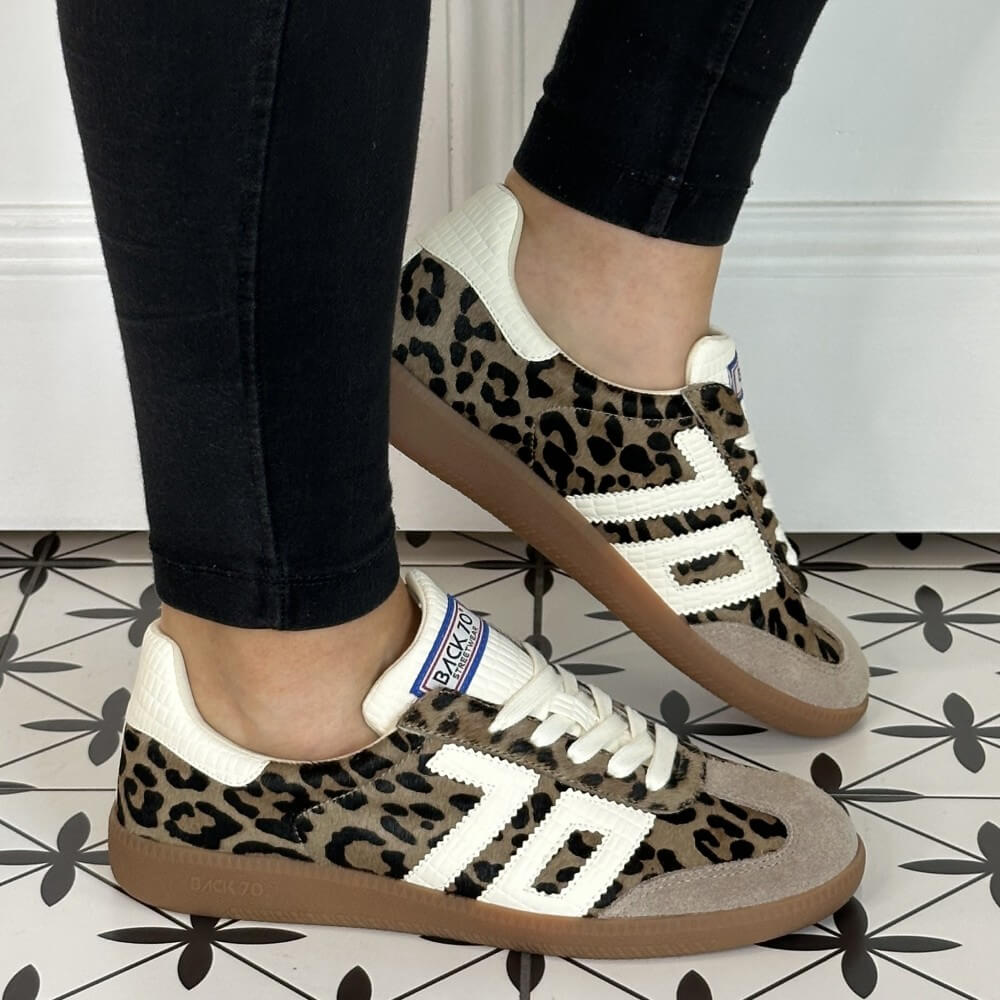 Leopard print sneakers with white accents worn indoors on a patterned floor. Back 70 Cloud Retro Sneaker in Leopard with Milk