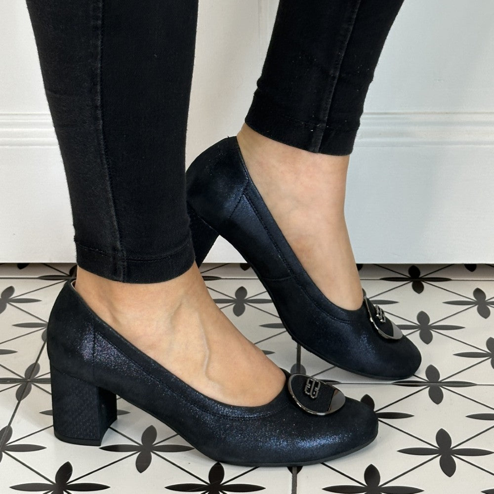 Navy Shimmer  high-heeled shoes worn with black pants on a patterned floor. Bioeco 6844 Block Heel Navy Shimmer Suede court shoes