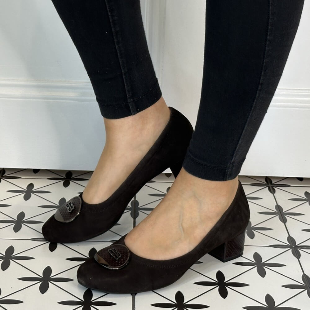 Brown suede shoes with a small heel worn by a person on a patterned floor. Bioeco 6861 Low Block Heel Brown Suede court shoes