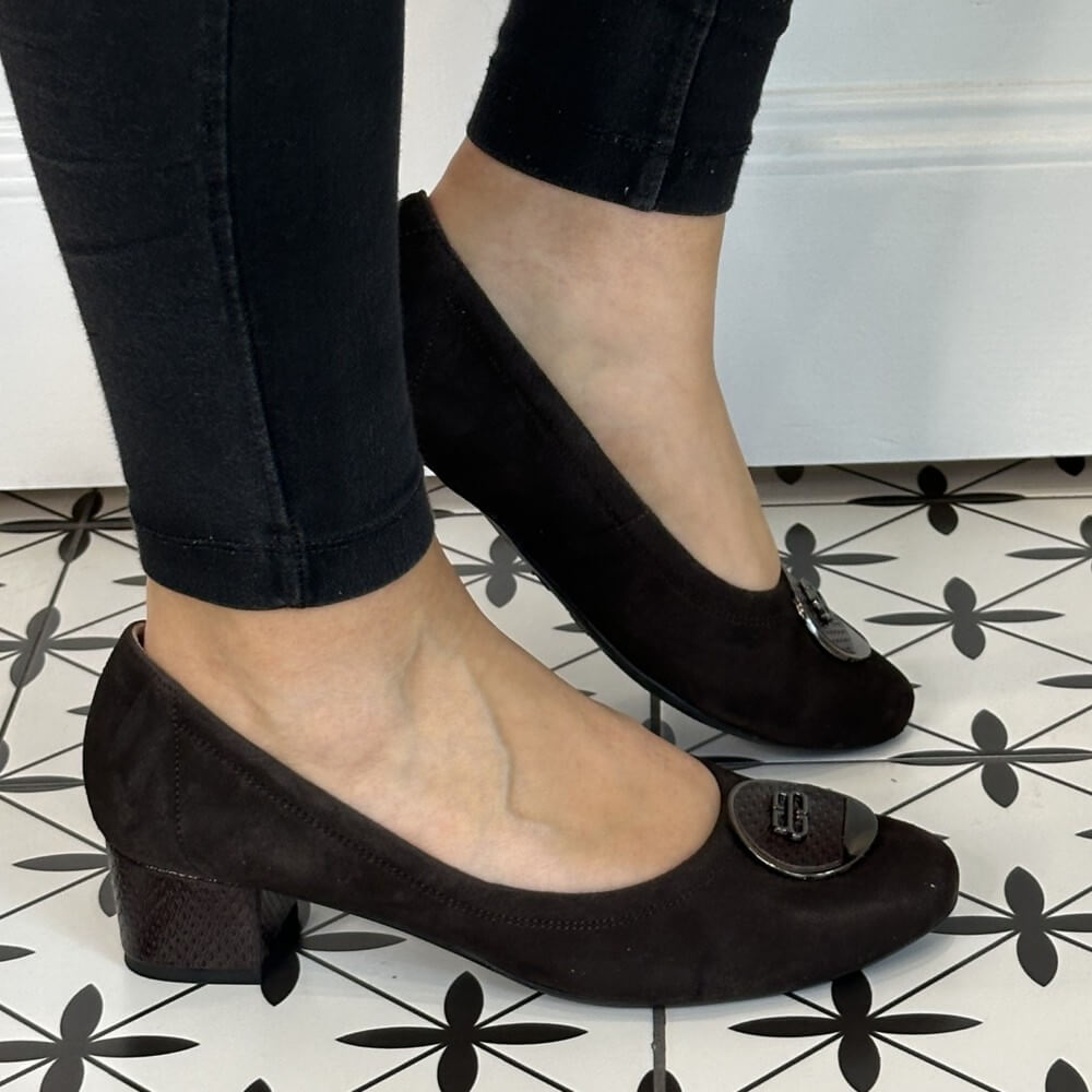 Brown suede shoes with a small heel worn by a person on a patterned floor. Bioeco 6861 Low Block Heel Brown Suede court shoes